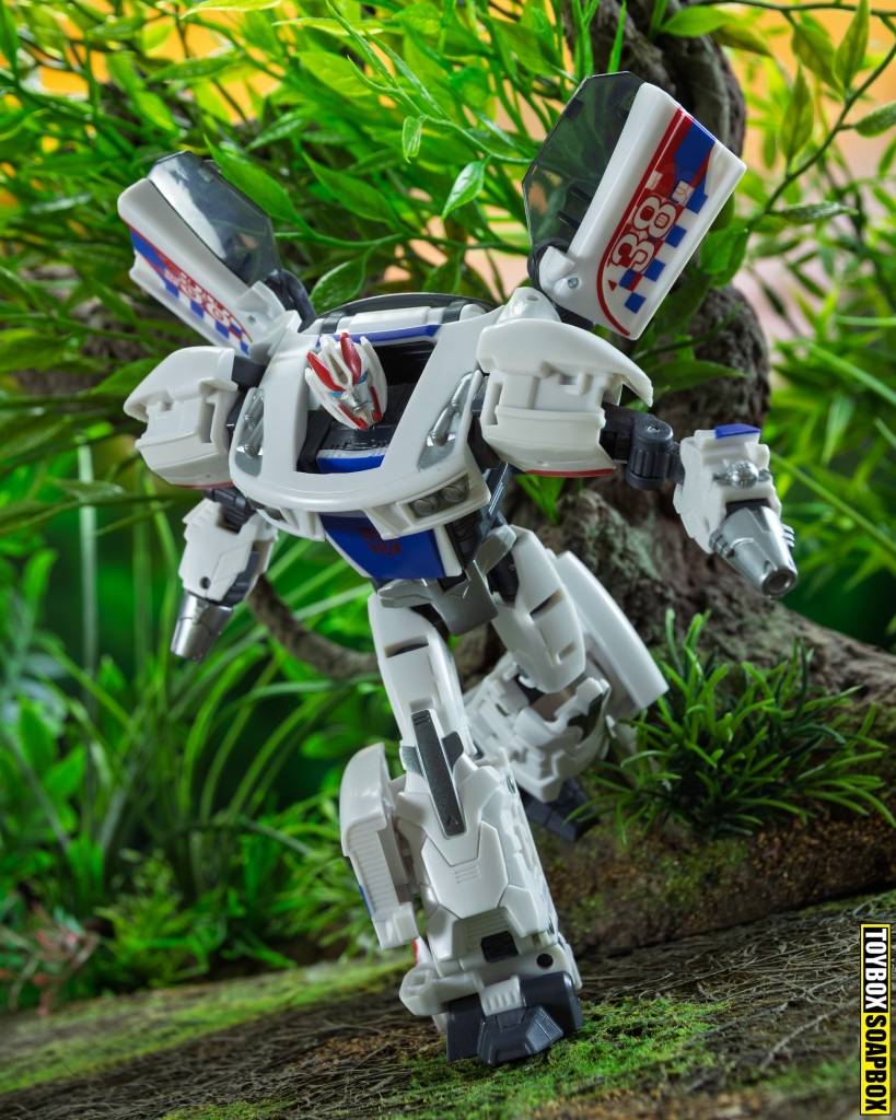 Transformers prime Age of the primes smokescreen in robot mode running through the jungle